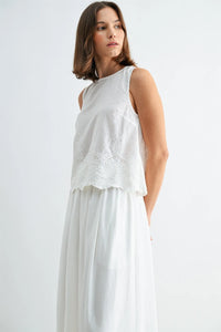 White sleeveless button blouse with eyelet hem and delicate lace embroidery across the chest and scalloped hemline