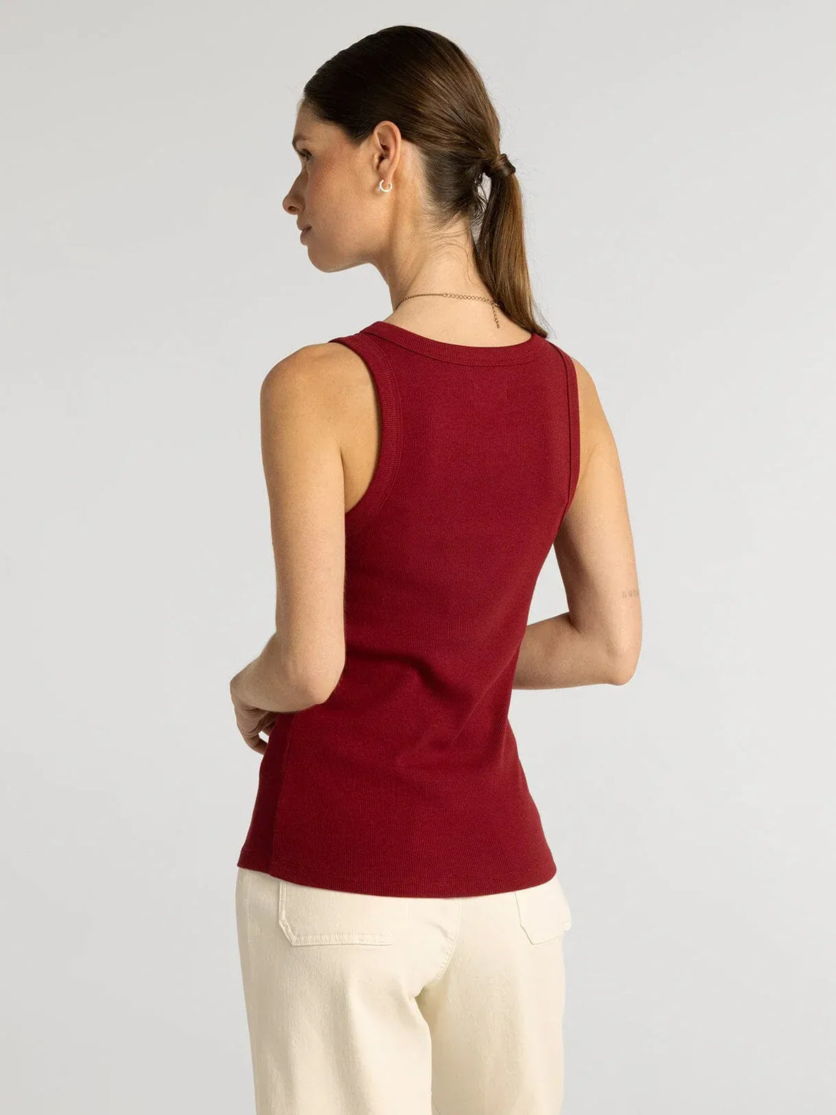 A fitted sleeveless red knit edlin basic tank with rounded neckline and ribbed trim by thread and supply
