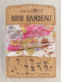 A floral-patterned boho bandeau headband in english garden cream featuring pink and yellow blossoms on stretchy fabric