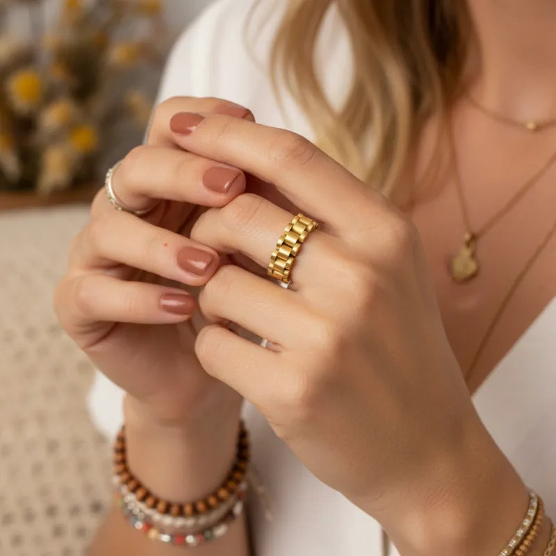 Gold dipped link statement ring showing a gold chain link design worn on a finger for elegant style