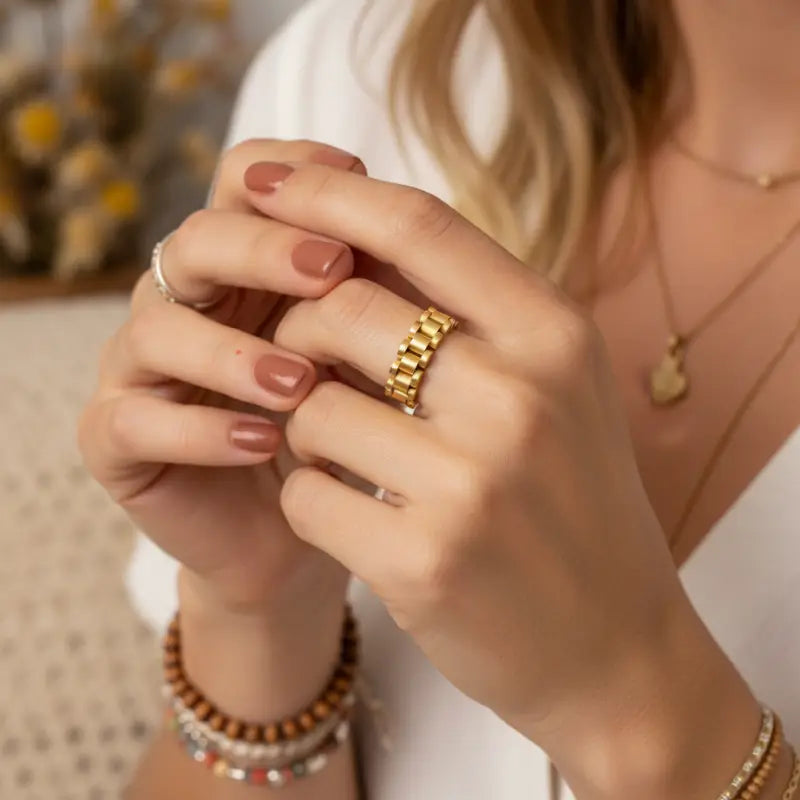 Gold dipped link statement ring showing a gold chain link design worn on a finger for elegant style