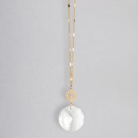 Gold chain necklace with small gear charm and round white translucent pendant pocket suncatcher for women’s boho chic clothing from shop daisy
