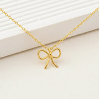 Gold dipped wire ribbon bow pendant necklace with delicate chain