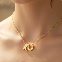 Gold dipped cowboy boots horse shoe charm necklace with star accents