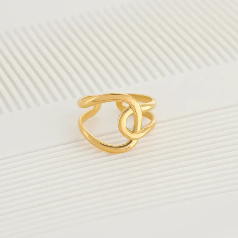 Gold-colored minimalist interlocked water resistant ring featuring an open design suitable for everyday wear