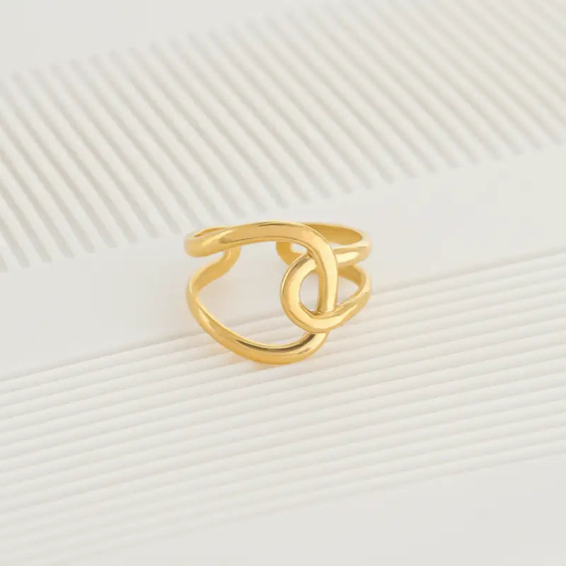 Gold-colored minimalist interlocked water resistant ring featuring an open design suitable for everyday wear