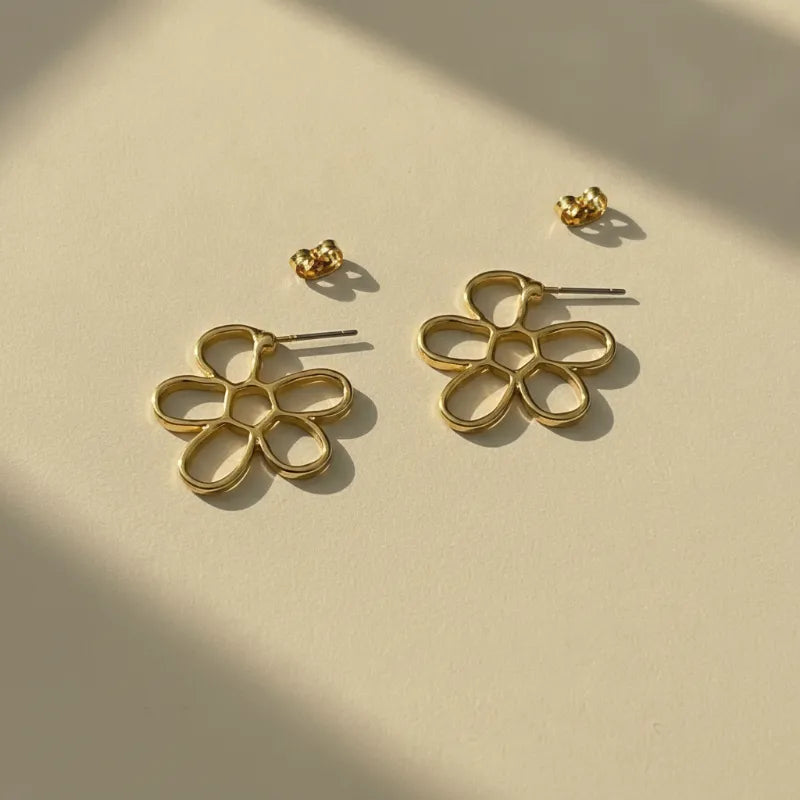 Gold outline daisy flower stud earrings featuring an elegant gold-colored minimalist openwork design