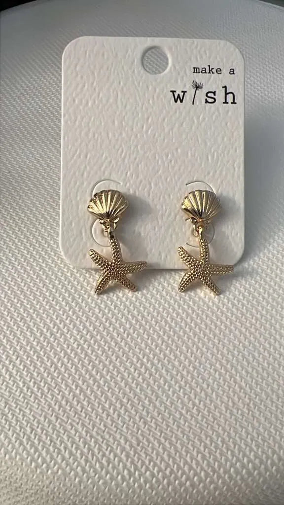Gold-colored textured shell and starfish sea life earrings displayed on a white card for elegant wear