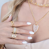 Gold open ring accented with cubic zirconia and pinkish heart pendant