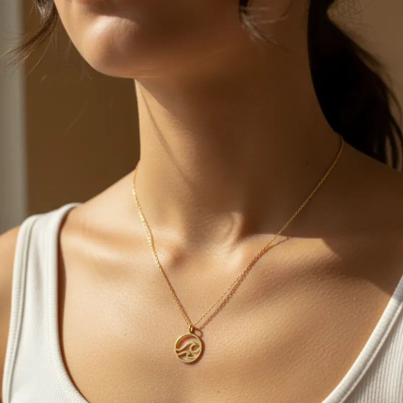 Gold dipped wave coin pendant necklace with intricate circular design