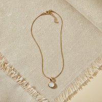 GOLD SNAKE CHAIN NECKLACE WITH ROUND MOTHER OF PEARL PENDANT