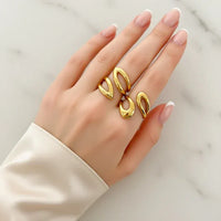 Water resistant two teardrop shapes ring in gold tone on hand