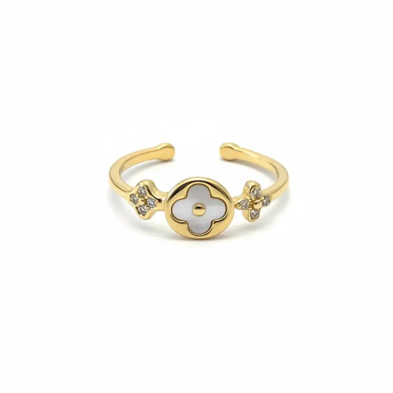 Gold-toned clover adjustable ring with a central white mother-of-pearl flower and diamond-studded floral accents