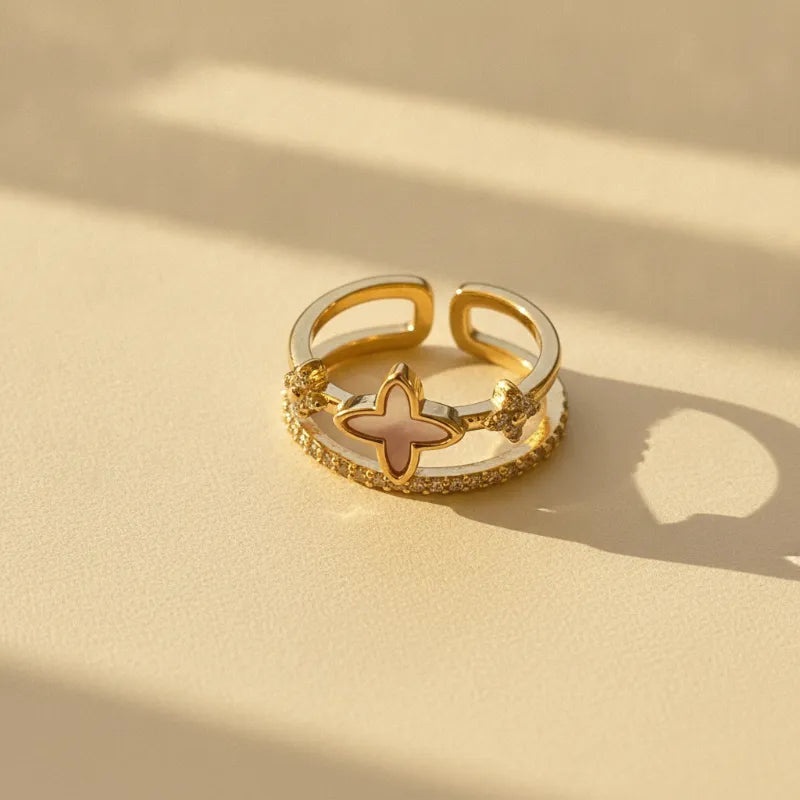 Gold-tone adjustable pearl gold statement ring with pink enamel four-leaf clover and clear stone accents