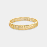 Gold-toned sun pattern bangle bracelet featuring intricate geometric and lattice pattern design in metal