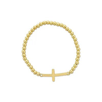Gold-toned cross beaded stretch bracelet with simple cross pendant featuring gold beads and elastic band design