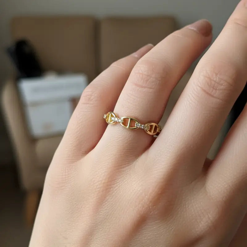 Gold-toned mariner link adjustable ring featuring chain-link design adorned with small clear stones