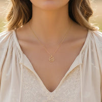 Gold dipped wave coin pendant necklace with minimalist design on delicate chain
