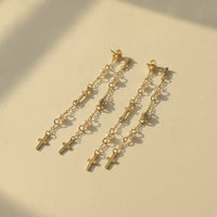 Chic gold filled dangle earrings featuring layered cross charms and pearls on delicate gold filled layered chains