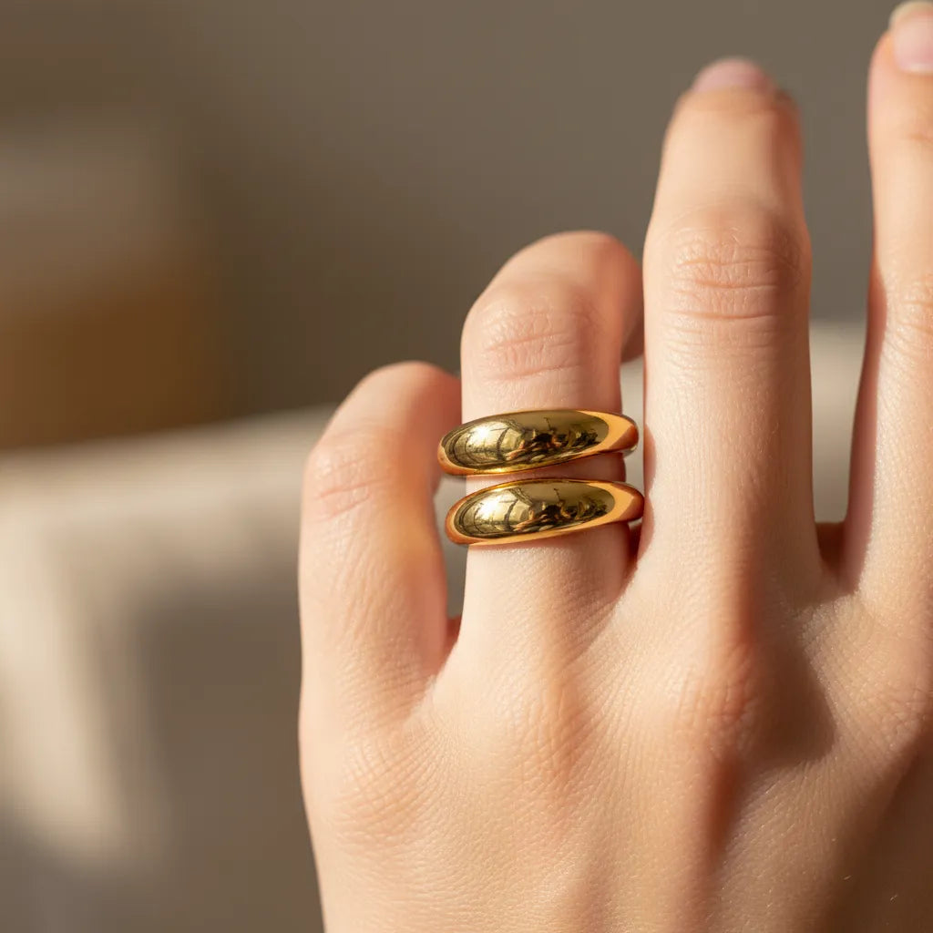 Gold-toned double band water resistant ring with a sleek reflective surface and adjustable design