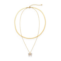 Gold-toned double snake chain necklace with double-layer sleek band and delicate chain featuring a sparkling bow charm