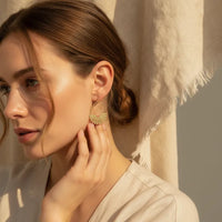Elegant gold fan teardrop statement earrings featuring gold-toned metal segments in a fan-shaped hoop design