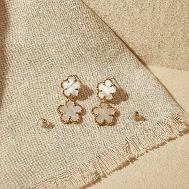 Elegant double flower mother of pearl gold drop earrings featuring gold-toned four-petal flower design with inlays