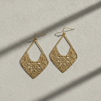 Elegant matte gold geometric hook earrings featuring intricate floral mandala filigree for statement jewelry