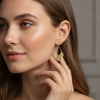 Elegant matte gold geometric hook earrings featuring intricate floral mandala filigree in dangle design