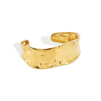 Gold-toned steel cuff with hammered surface water resistant design and textured irregular open style