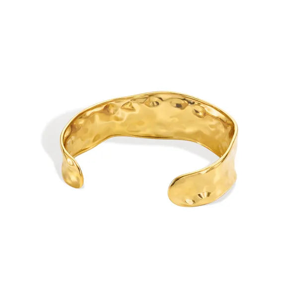 Gold-toned hammered surface water resistant cuff bracelet with textured organic shape made of steel
