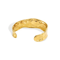 Gold-toned hammered surface water resistant cuff bracelet with textured organic shape made of steel