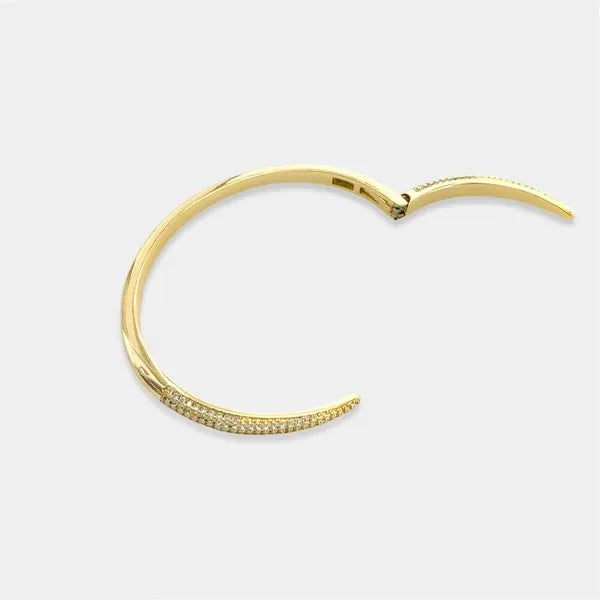 Gold-toned cubic zirconia open cuff bangle bracelet with hinged design and row of small sparkling stones along edge