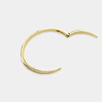 Gold-toned cubic zirconia open cuff bangle bracelet with hinged design and row of small sparkling stones along edge