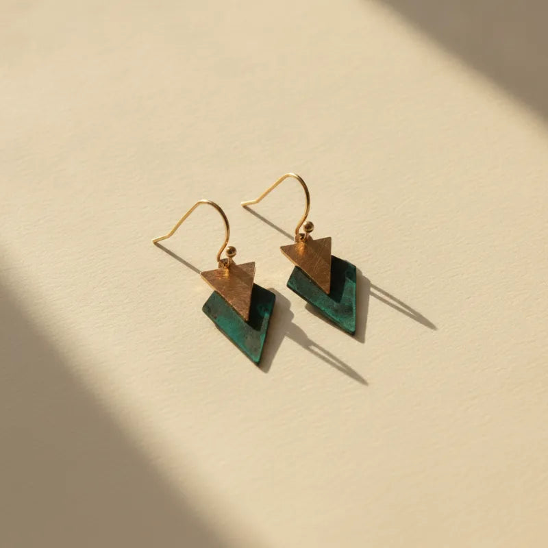 Gold-toned geometric drop earrings with rustic copper and deep teal layered triangles for a modern minimalist look