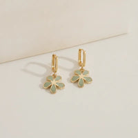 Gold rectangular hoops with gold-toned delicate five-petal flowers featuring sage green floral enamel charms