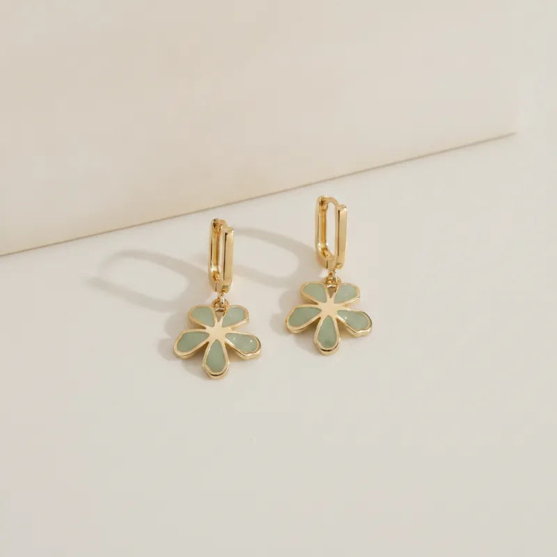 Gold rectangular hoops with gold-toned delicate five-petal flowers featuring sage green floral enamel charms
