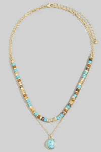 Gold-toned layered turquoise stone drop bead necklace featuring turquoise and earthy brown beads with matching pendant
