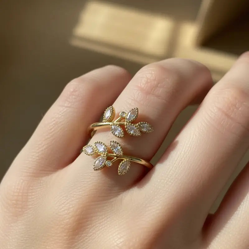 Ethereal leaf adjustable ring in gold tone with marquise cut clear stones featuring leaf design