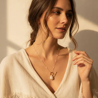 Gold plated beaded chain necklace with a gold-toned ornate key pendant featuring a single pearl pendant