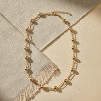 Chic minimalist gold ball and bar link chain necklace featuring gold-toned spherical beads and rectangular links