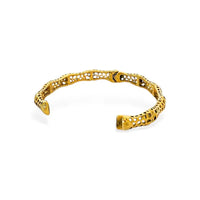 Gold-toned open bangle with intricate lace-like sculptural lattice design filigree detailing in a lattice design bangle style