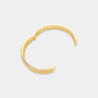 Gold-toned open sun pattern bangle featuring an intricate textured pattern for elegant wristwear