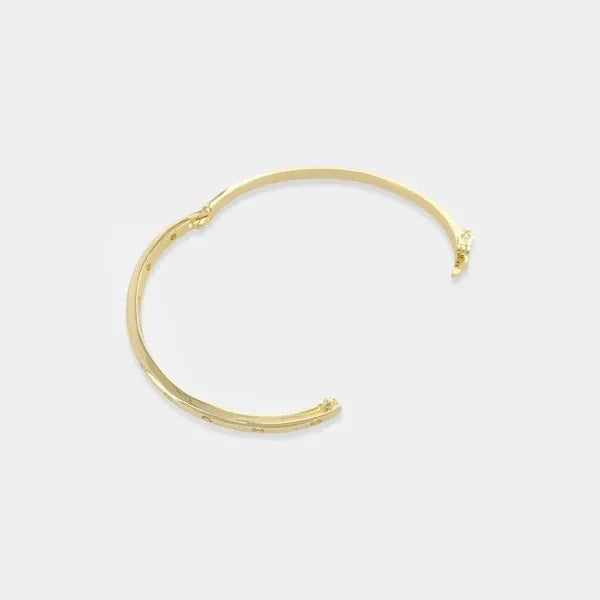 Thin polished cubic zirconia bangle bracelet in gold tone with small embedded cubic zirconia stones