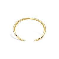 Gold-toned crisscross shape open cuff bracelet with a delicate beaded texture along its inner edge