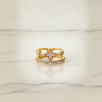 Mother of pearl gold statement ring featuring a gold statement ring with a four-leaf clover and pink enamel inlay