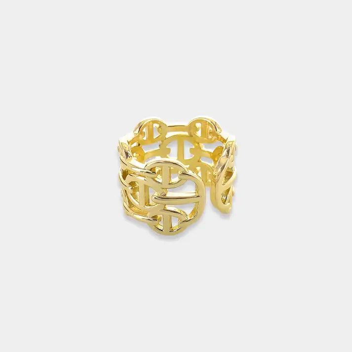 Gold-toned ring with an intricate, interlocking geometric design.