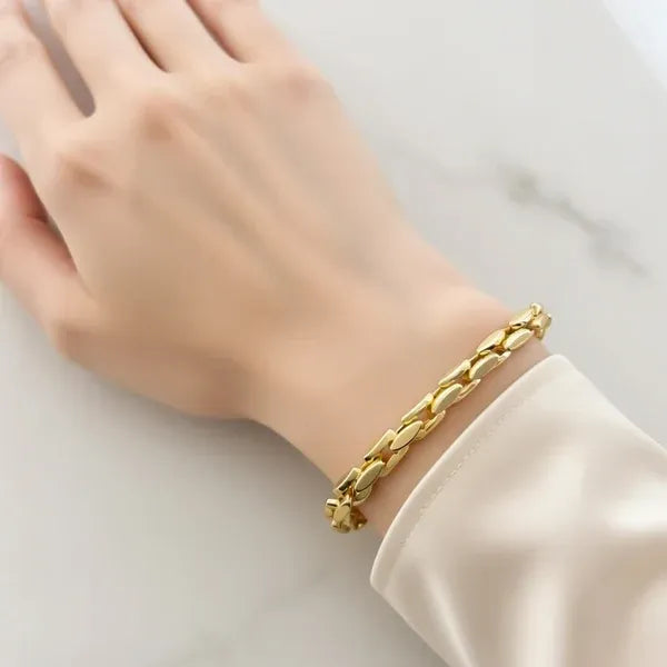 Gold-toned sleek oval-link toggle chain bracelet worn on wrist showcasing elegant chain bracelet design
