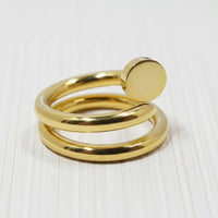 Gold coil nail ring featuring a gold-toned spiral design with a smooth circular accent at the top
