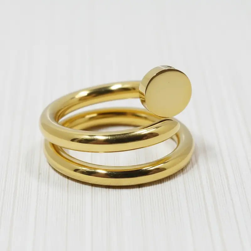 Gold coil nail ring featuring a gold-toned spiral design with a smooth circular accent at the top